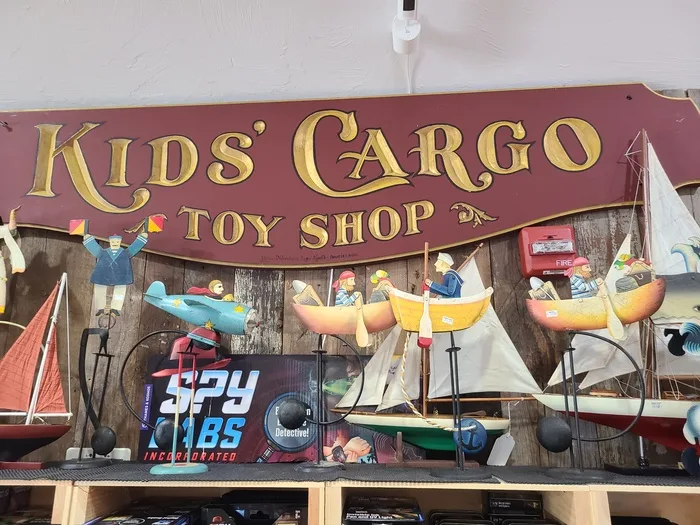 Kids' Cargo Toy Shop wooden sign inside the store
