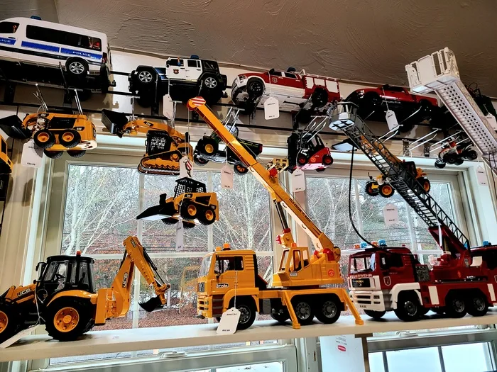 Toy trucks, excavators and fire engines on display